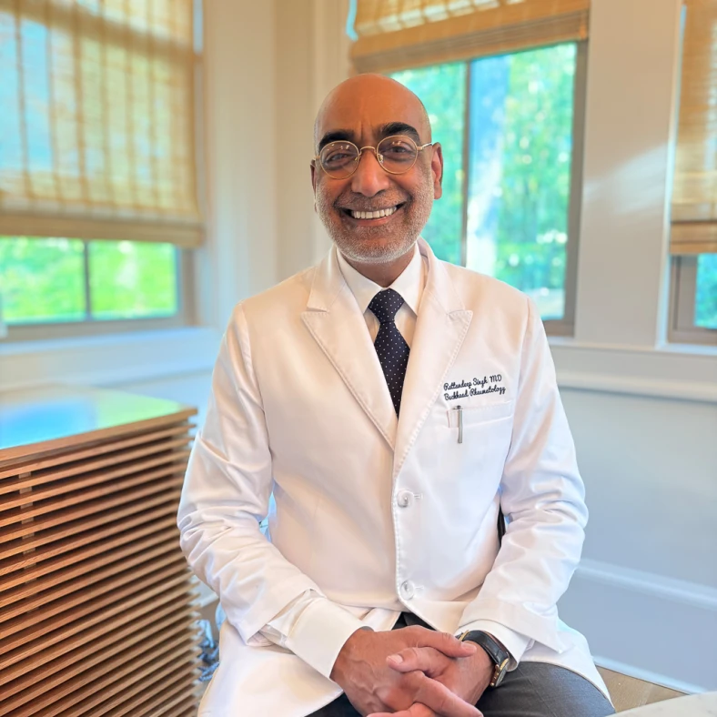 Rattandeep Singh, MD, consulting with a patient